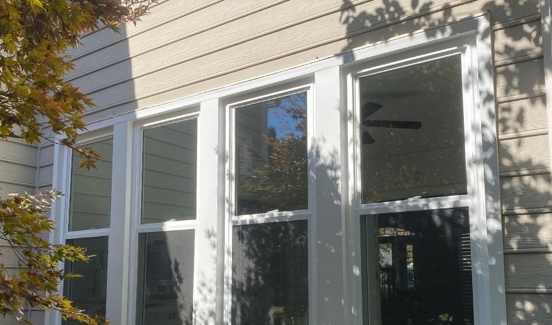 After: the same opening with new clean-lined replacement windows and no grid.