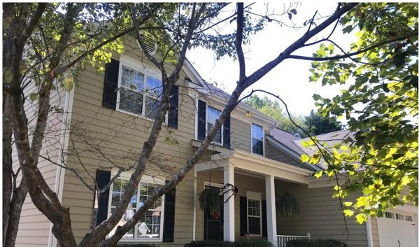 Before: a cream colonial under a large tree, shaded and dated.