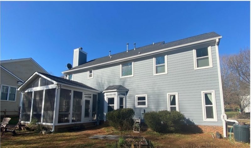 After: the same rear elevation in pale blue-gray with the bed cleared and planted.