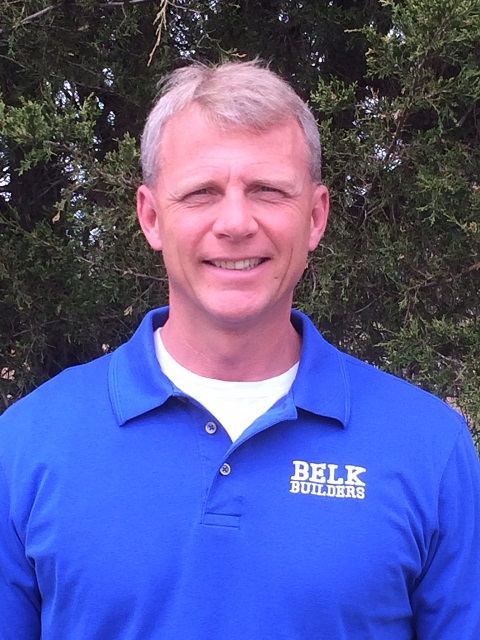 Kent Frerichs, owner of Belk Builders, outdoors in a Belk Builders polo shirt