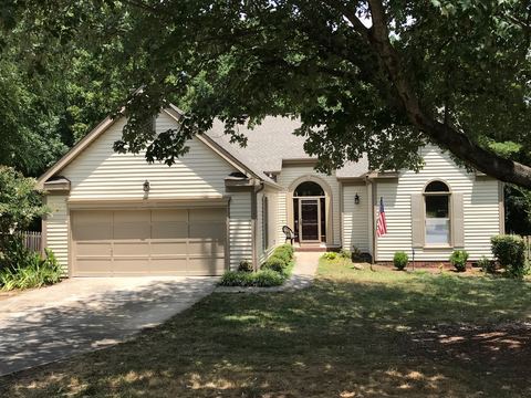 Cream vinyl siding on a single-story home with a two-car garage
