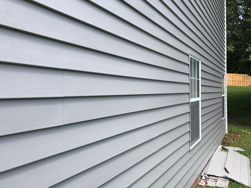 Close-up of a long run of gray lap siding with no visible seams