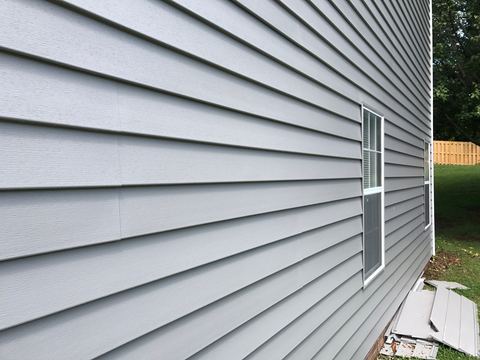 Close-up of a long run of gray lap siding with no visible seams