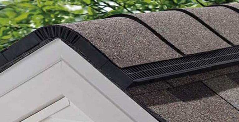 Close-up of a shingle-over ridge vent running along a roof peak