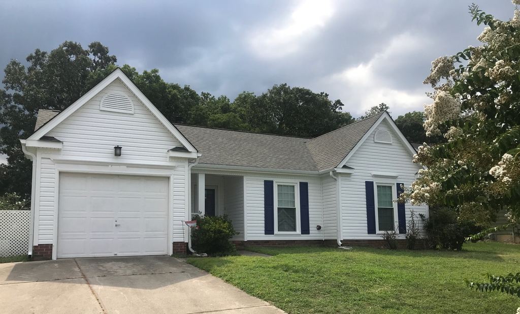 White vinyl siding with blue shutters on a single-story home