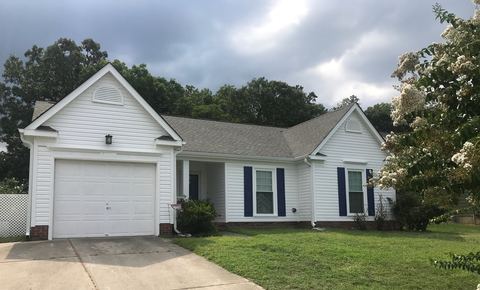 White vinyl siding with blue shutters on a single-story home