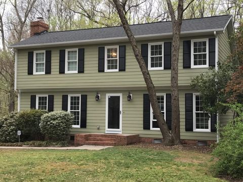 Sage green siding, white trim and black shutters on a completed two-story colonial