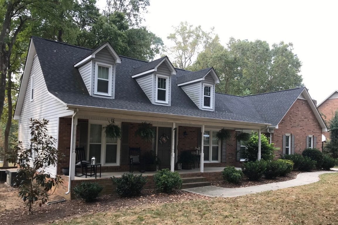 Notice the two vertical grids in top sash only. Double-hung windows.
