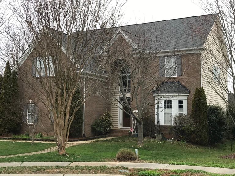 Brick two-story home with a new gray architectural shingle roof