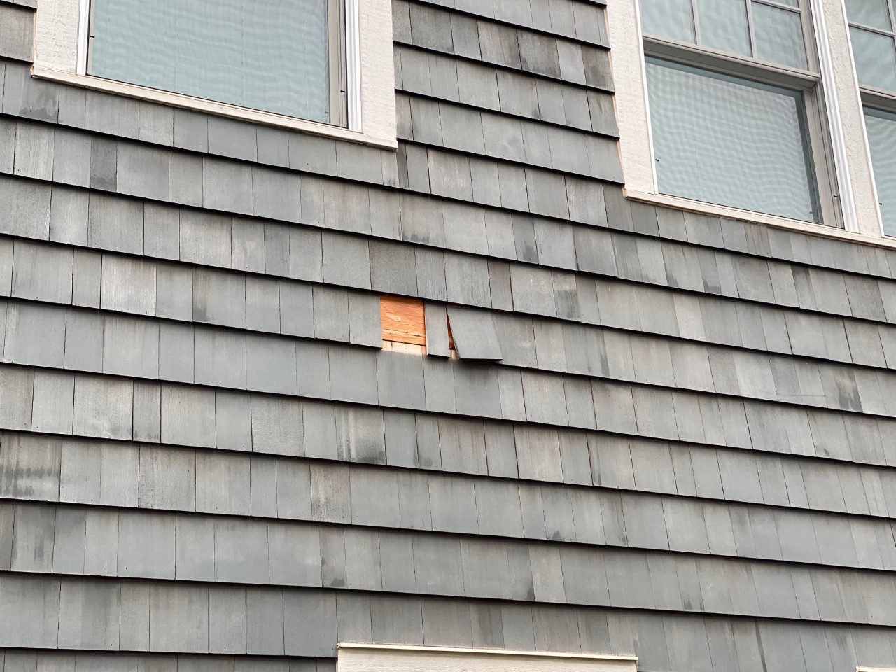 Before: peeling areas of siding