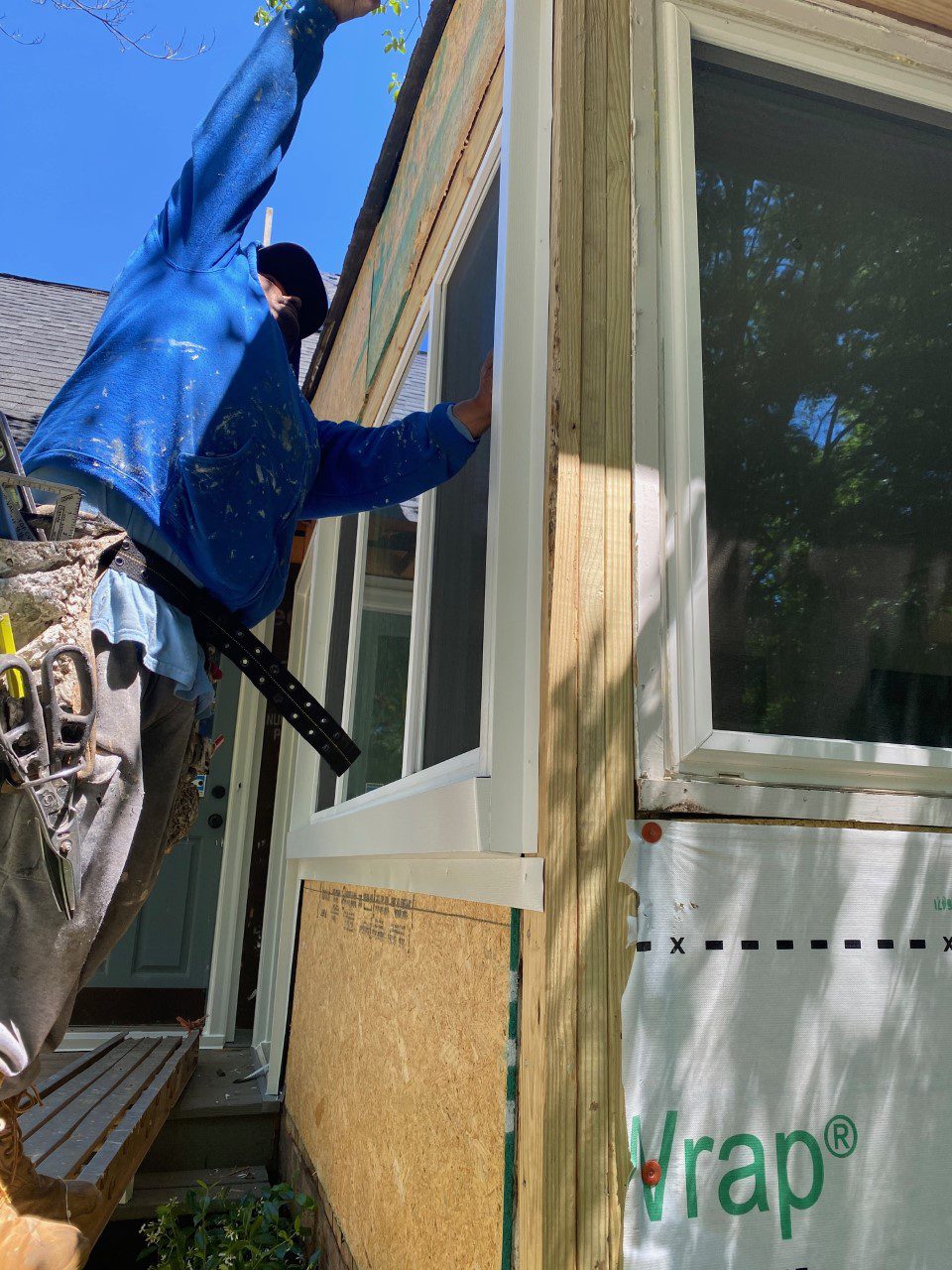 removal of masonite and new siding installation underway