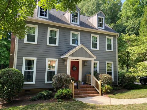 Blue-gray lap siding with white trim and dormer windows on a two-story home