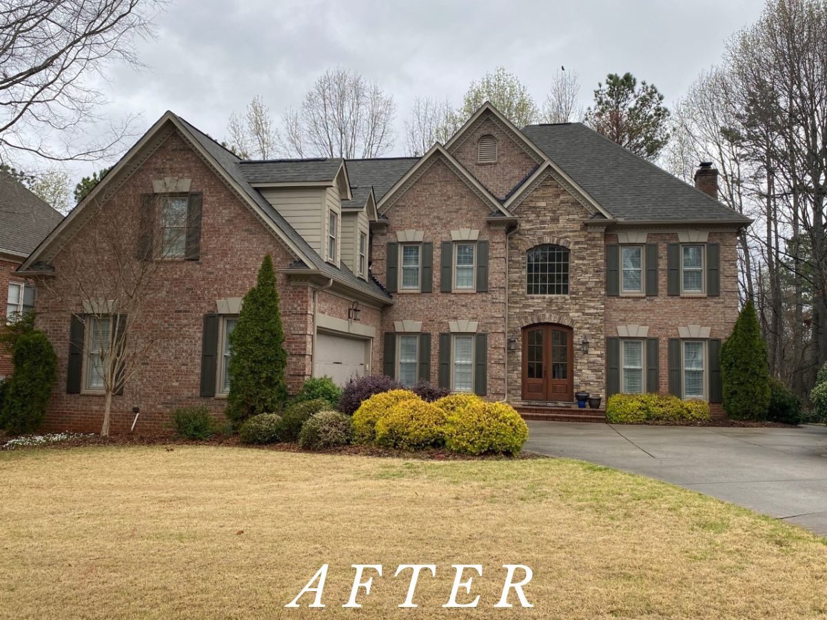 After: the same home with dark custom shutters fitted to every front window.