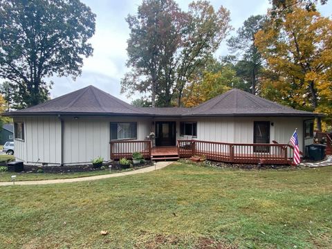 Single-story home with a wraparound deck and board-and-batten siding