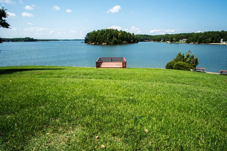 Lake Wylie shoreline seen across a green lawn from Tega Cay, South Carolina