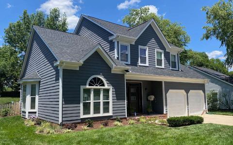 Two-story home in blue-gray siding under a new gray architectural shingle roof