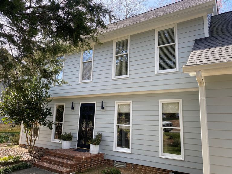 Light gray fiber cement lap siding with white trim on a two-story Charlotte-area home