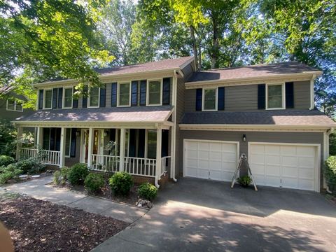 Cream siding with white trim on a two-story home with a covered porch and two-car garage