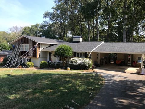 Single-story home with an attached carport during an exterior replacement project