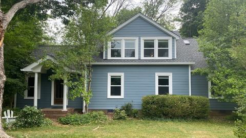 Blue-gray home with white replacement windows and a covered entry