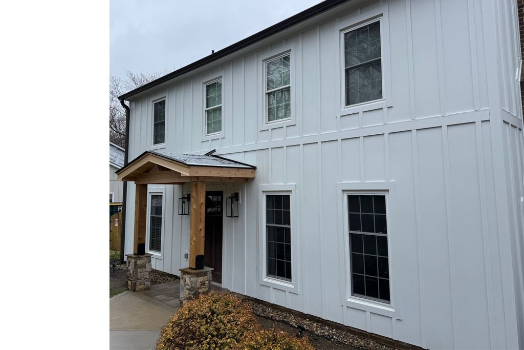 White board-and-batten fiber cement siding on a two-story home with a wood-post entry