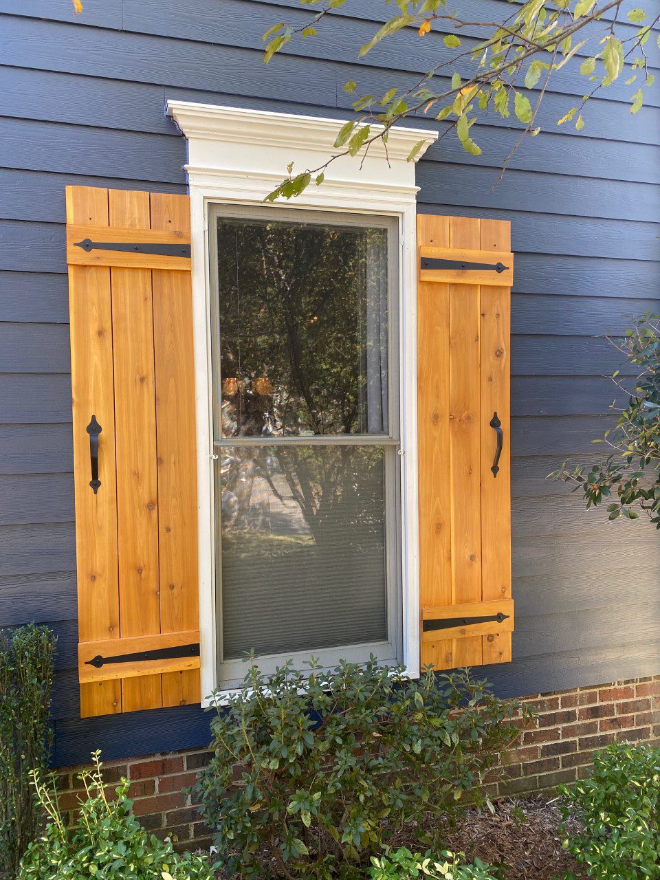 Red cedar shutters on ocean blue Hardie® Plank siding tega cay sc